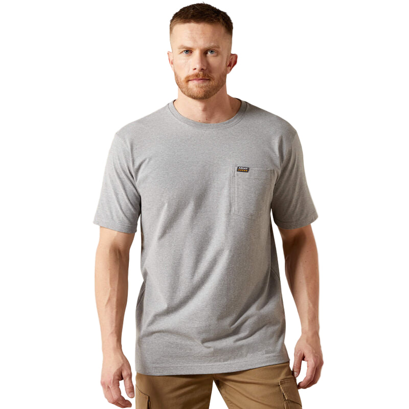 Man wearing a gray t-shirt with a brand logo on a beige background