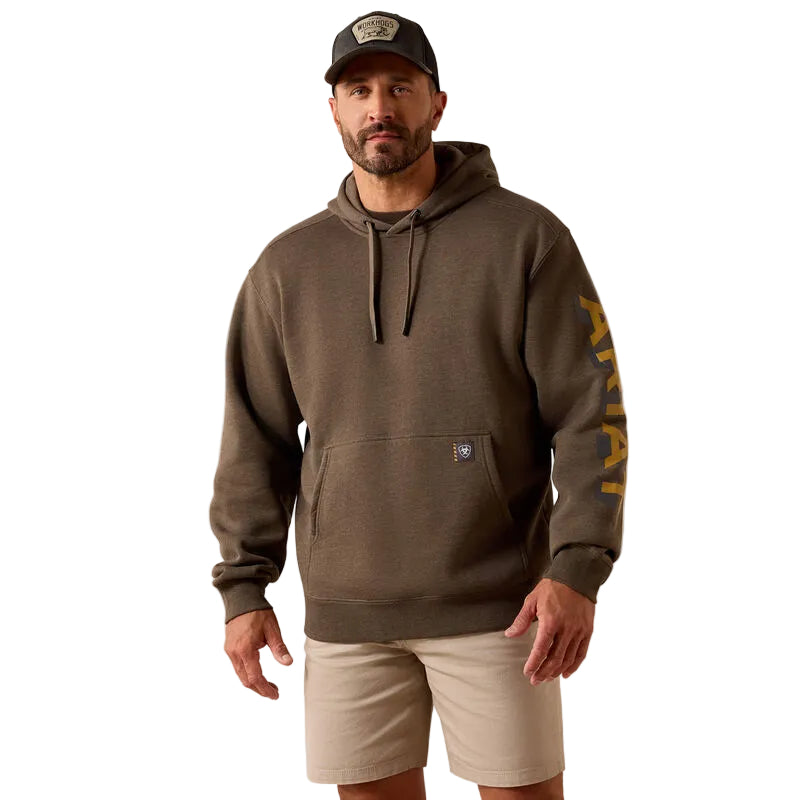 Man wearing a brown hoodie with a logo on a beige background