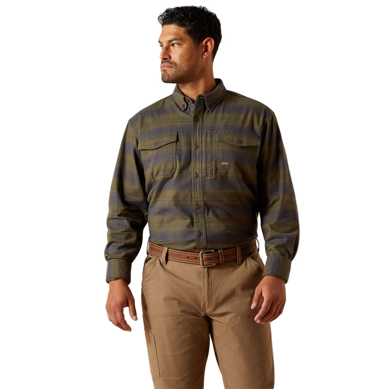 Man wearing a plaid shirt and khaki pants on a beige background